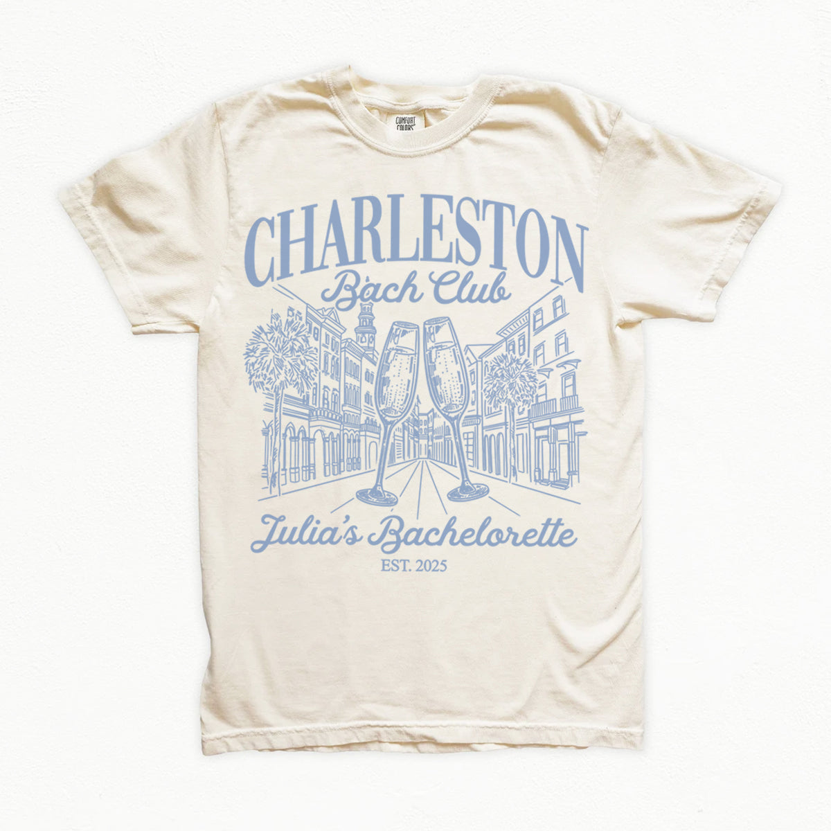 Beige bachelorette t-shirt with blue graphic and text on a white background