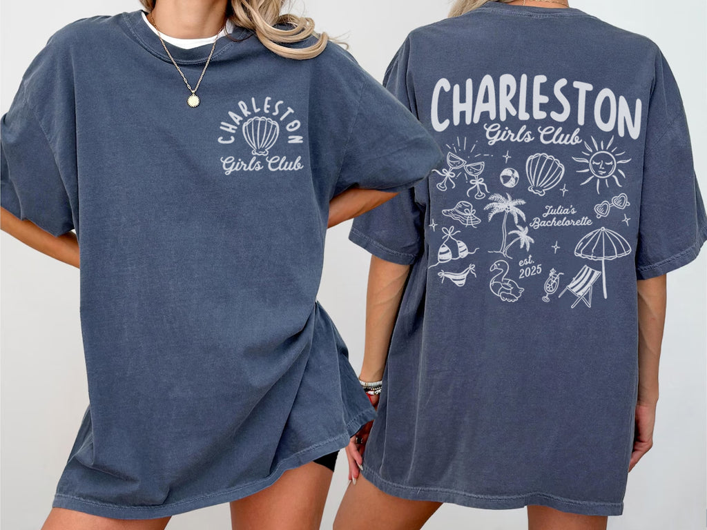 Two people wearing navy blue bachelorette t-shirts with 'Charleston Girls Club' branding on a plain background.