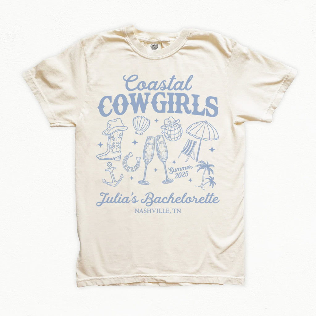 Beige bachelorette t-shirt with blue 'Coastal Cowgirls' design on a white background