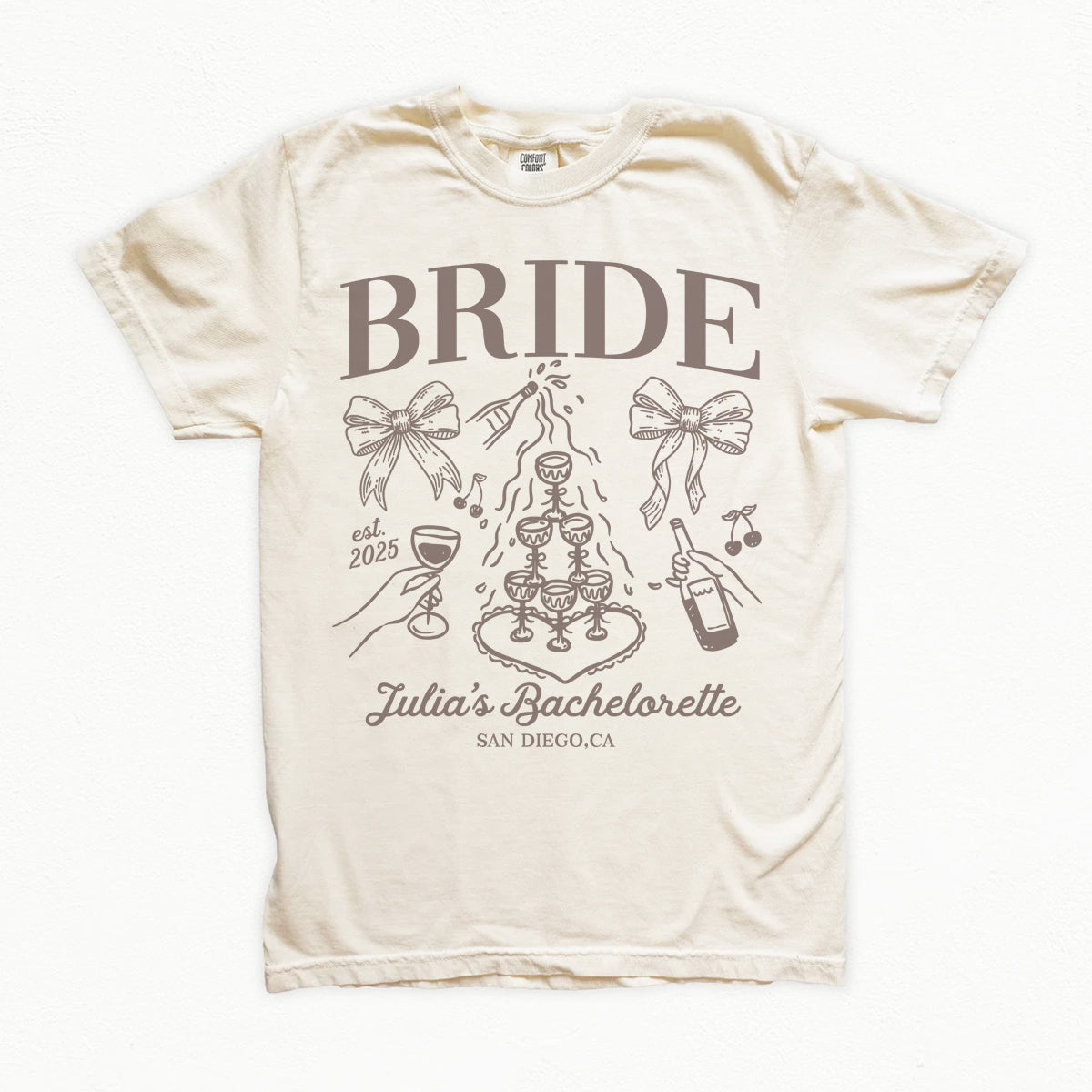 Beige bachelorette t-shirt with 'BRIDE' and bachelorette party design on a white background
