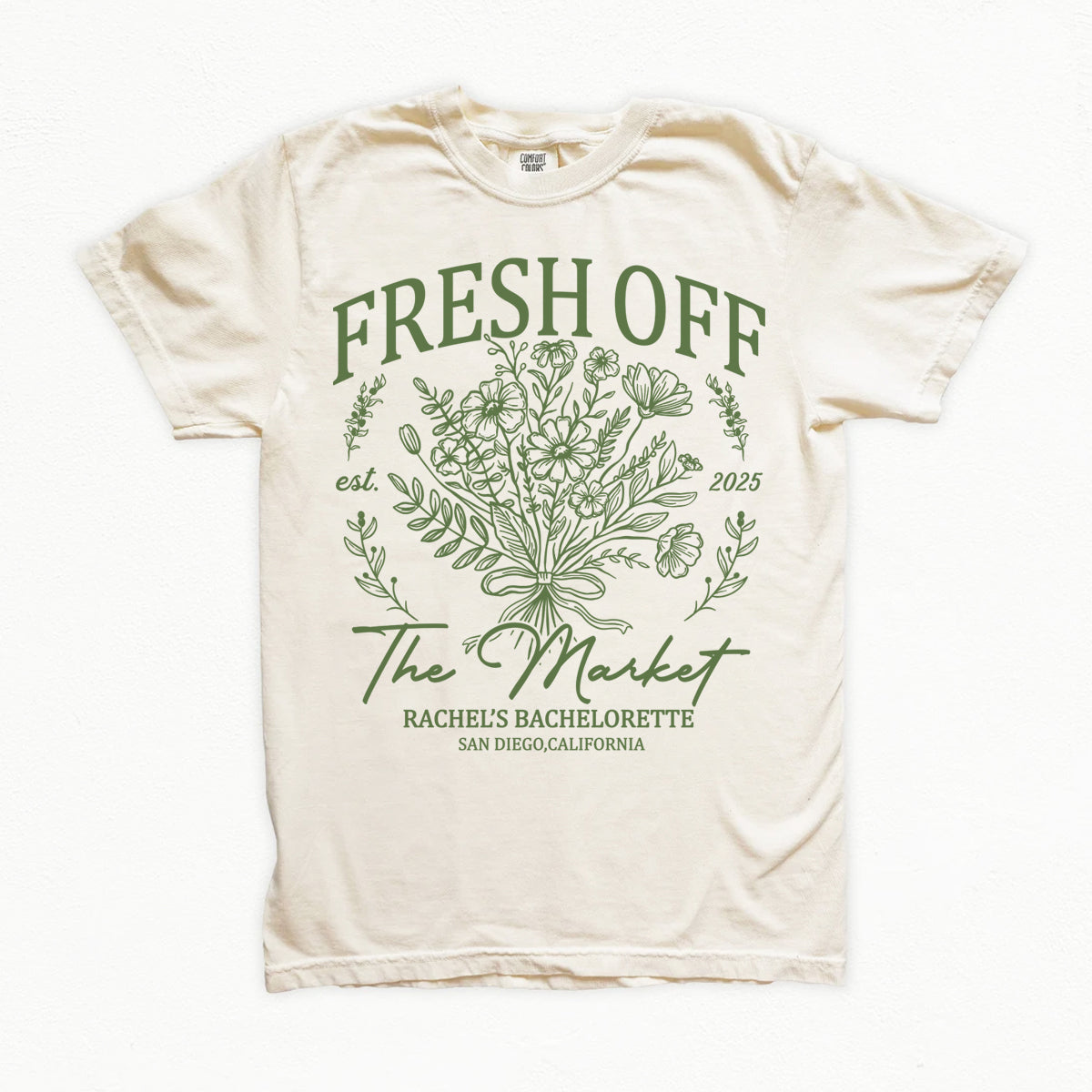 Beige bachelorette t-shirt with green floral design and text on a white background