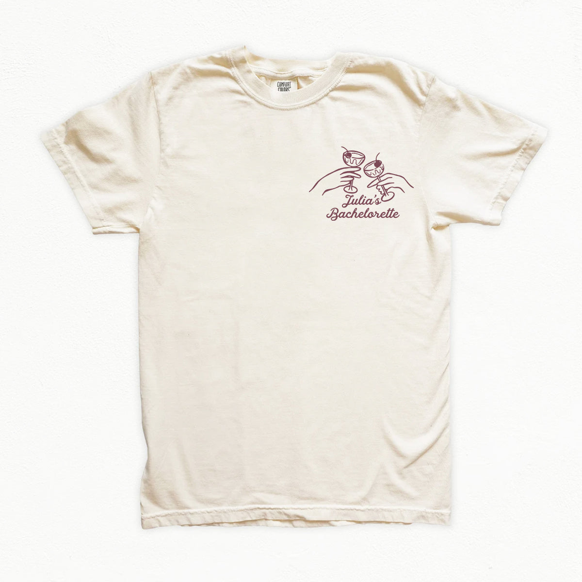 Beige bachelorette t-shirt with a decorative design and text on a white background