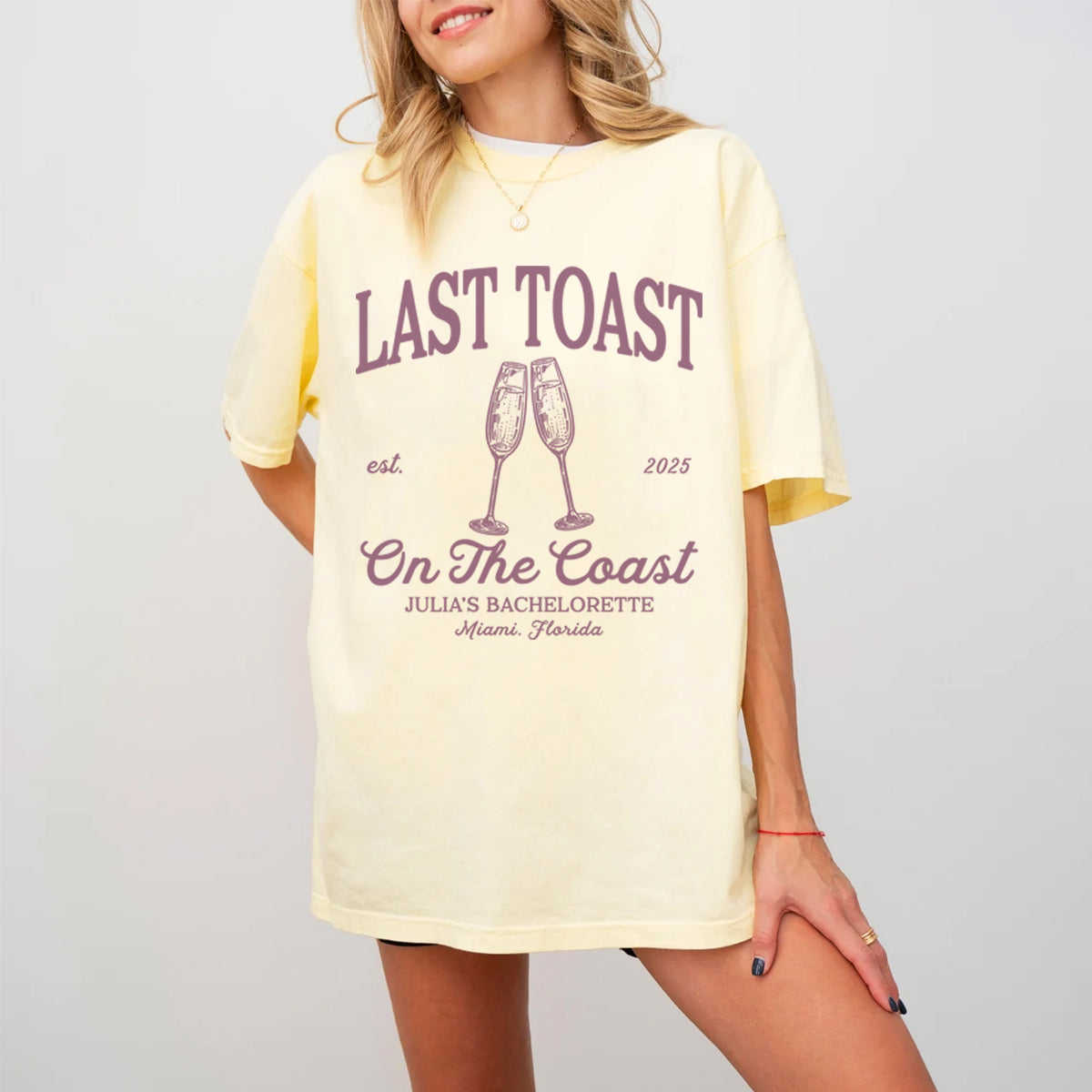 Woman wearing a yellow bachelorette t-shirt with 'Last Toast on the Coast' text and graphics.