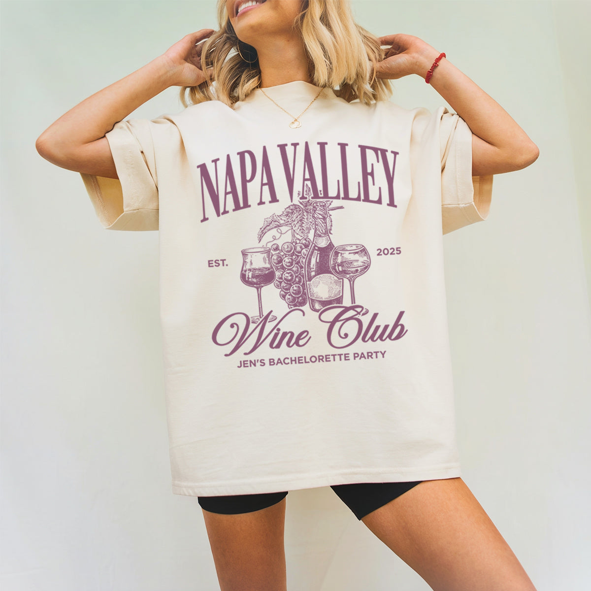 Person wearing a 'Napa Valley Wine bachelorette Club' themed t-shirt with a plain background