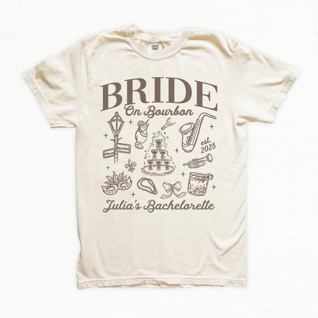 Beige t-shirt with 'Bride on Bourbon' design and text on a white background