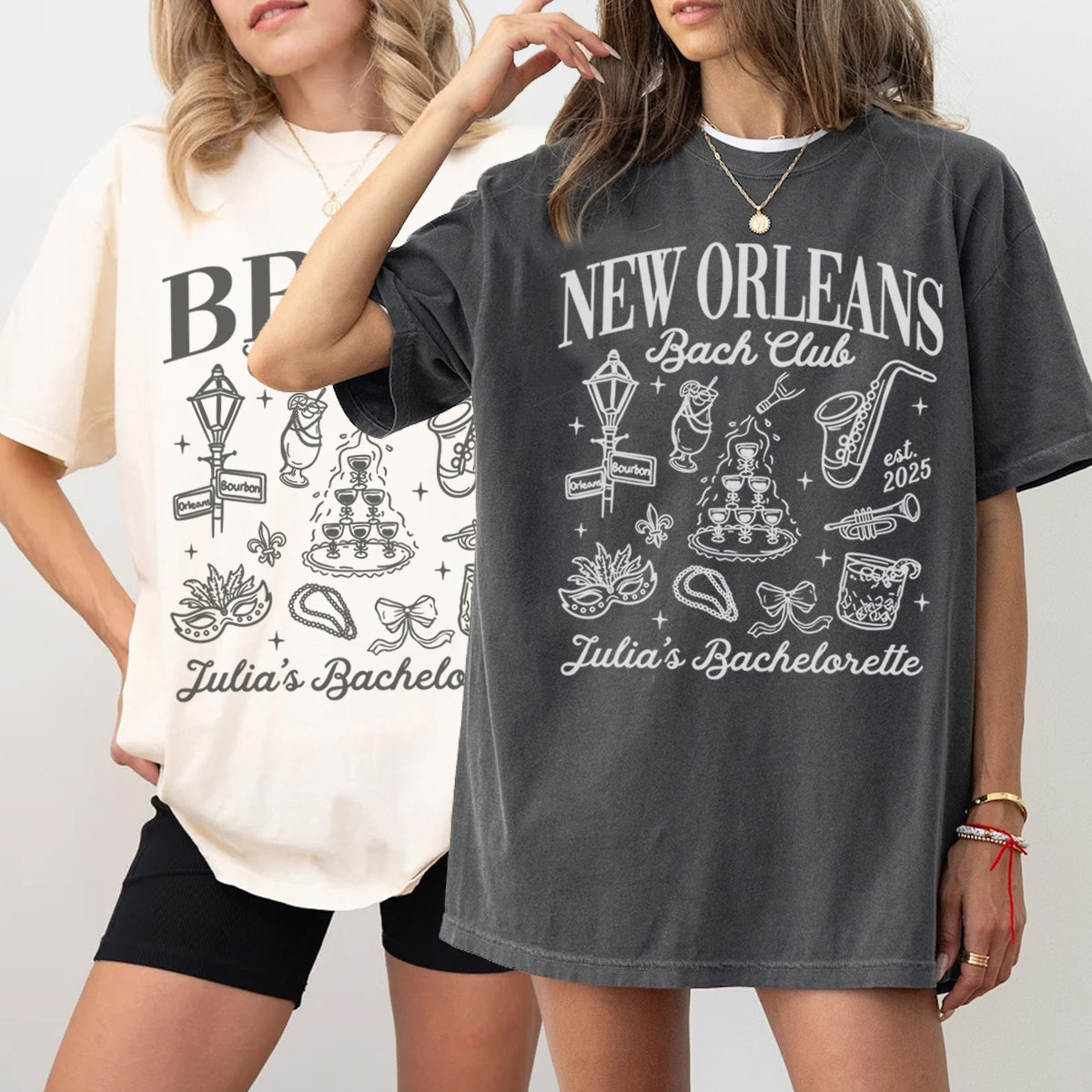 Two women wearing t-shirts with 'New Orleans Bach Club' designs on a plain background