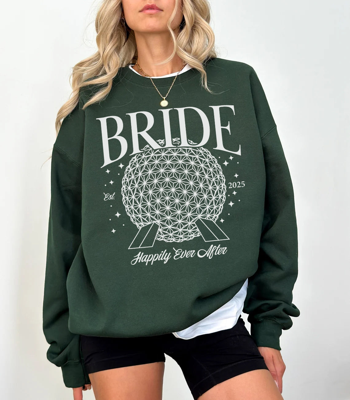 Green sweatshirt with 'BRIDE' and floral design worn by a person on a white background