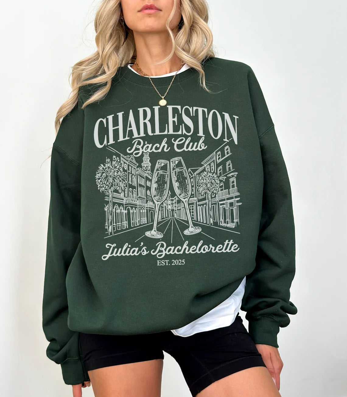Green sweatshirt with 'Charleston Bachelorette Club' design worn by a person on a white background