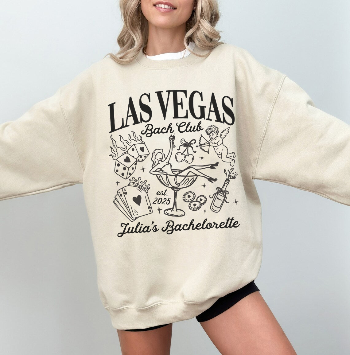 Beige sweatshirt with 'Las Vegas Bach Club' design and text, worn by a model on a plain background